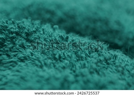 green cloth with fine fibers on the surface, which has abstract waves