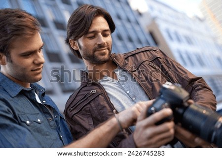 Men, friends and photographer with camera in outdoor, capture and city for creativity in London. Collaboration, photography and take picture of urban town, events and buildings for portfolio