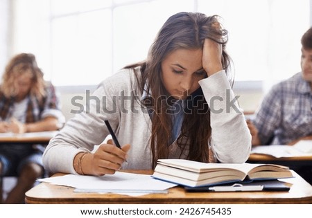 University, classroom and woman with stress for exam, education and opportunity. College, learning and tired student with book, fatigue and anxiety for test, assessment or studying report with notes.