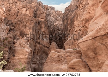 The unique  beauty of high mountains on both sides of dry stream in gorge Wadi Al Ghuwayr or An Nakhil and the wadi Al Dathneh near Amman in Jordan