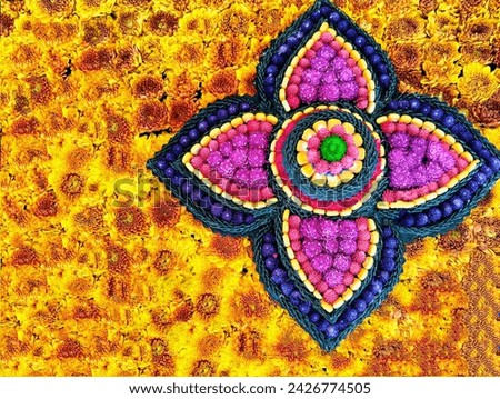The background picture is fresh flowers, orange carnations, in the center of the picture is a circle of flowers and orange corn seeds, decorated with multi-colored amaranth flowers.
