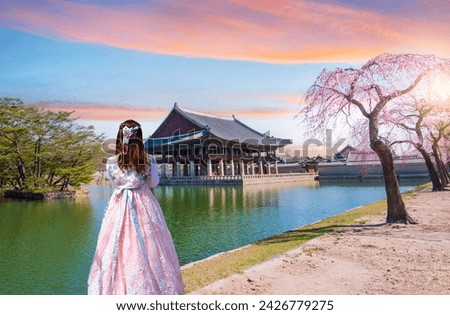Woman wearing colorful hanbok Korean national costume with South Korea's spring in Gyeongbokgung Palace in Seoul, South Korea