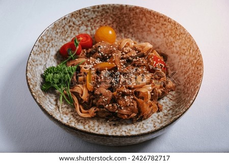 udon noodles with duck meat, herbs, sesame seeds and cherry tomatoes