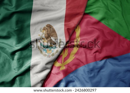 big waving national colorful flag of eritrea and national flag of mexico . macro