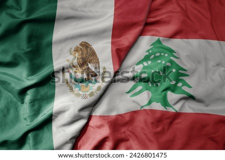 big waving national colorful flag of lebanon and national flag of mexico . macro