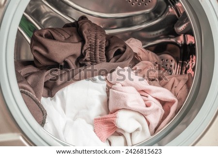 Washing machine loaded with clothes close up