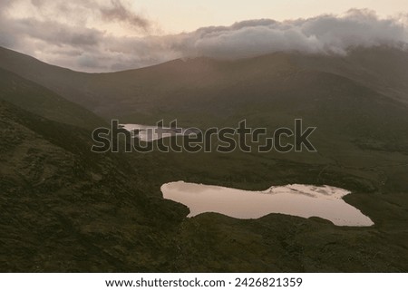 Conor Pass, one of the highest Irish mountain passes served by an asphalted road, located on the south-western end of the Dingle Peninsula, County Kerry, Ireland Royalty-Free Stock Photo #2426821359