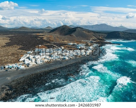 El Golfo: A quaint village embracing the wild Atlantic, set against Lanzarote dramatic volcanic landscape, a striking scene for any viewer. Royalty-Free Stock Photo #2426831987