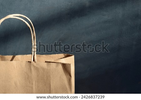 Kraft bag with shopping on the background of an old concrete wall
