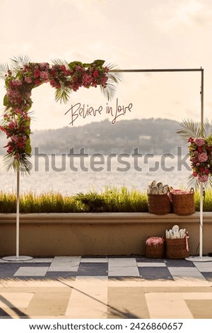 The arch adorned with flowers and the inscription 'Believe in Love' prepared for the wedding. stock photos