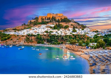 Lindos city on Rhodes island, Greece.  Small whitewashed village and the Acropolis, on Rhodos Island, Greece at Aegean Sea Royalty-Free Stock Photo #2426883883