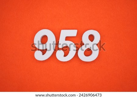 Orange felt is the background. The numbers 958 are made from white painted wood.