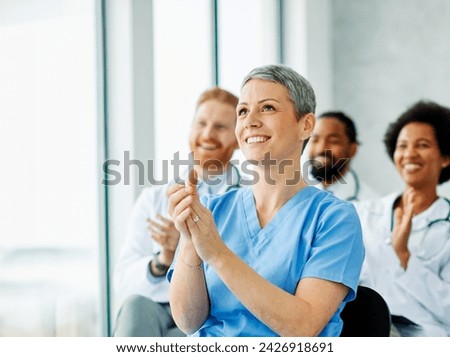 Portrait of a young doctors and nurses in audiance during a seminar in a board room or during an educational class at convention center  Royalty-Free Stock Photo #2426918691