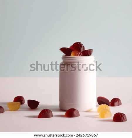 chewable supplements, nutritional gummies, edible health concept. colorful marmalades and bottle for your mock up or design. copy space square Royalty-Free Stock Photo #2426919867