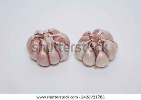 several cloves of garlic at flat lay on a white background