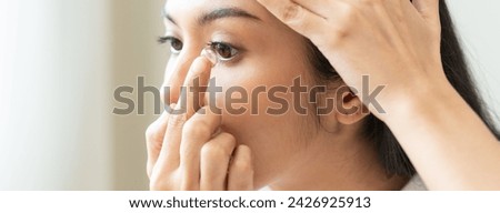 Optimise vision by contact lens, Close-up of woman face during insert contact lens to her eyes.