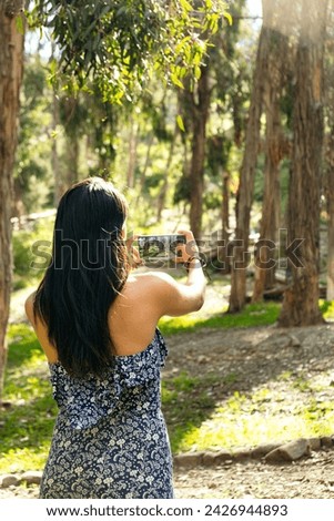 vertical photo latina woman taking a picture of the forest in bolivia - nature concept