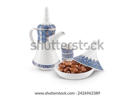 Porcelain Arabic Coffee pot, cups and dried dates bowl isolated on white background Royalty-Free Stock Photo #2426962389