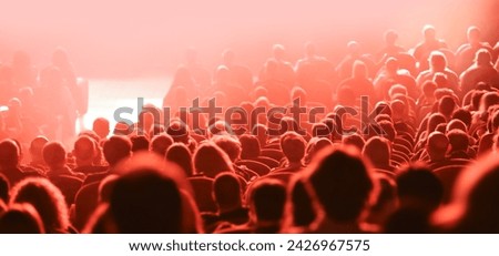 many heads of people during live concert and red lights Royalty-Free Stock Photo #2426967575