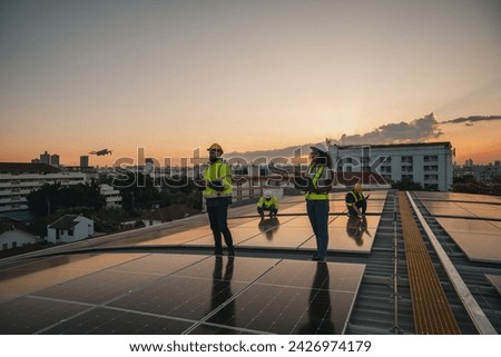 Service engineer checking solar cell on the roof for maintenance with drone technology. Engineer worker install solar panel. Clean energy concept.