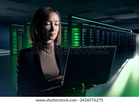 Woman in data center. Businesswoman in server room. Girl is system administrator. Computer science specialist. Woman stands in data center with servers. Telecommunications company engineer