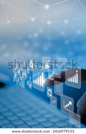 Businesswoman using laptop in data management.with a networked, vertical Royalty-Free Stock Photo #2426979133