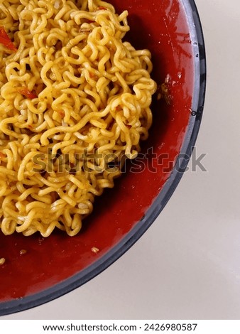 Fried instant noodles with sliced chili – a savory and spicy culinary delight that combines the convenience of instant noodles with the fiery kick of chili slices.