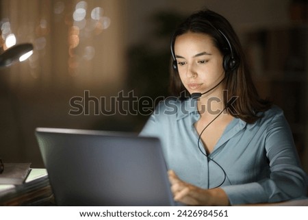 Tele operator working online in the night at home Royalty-Free Stock Photo #2426984561