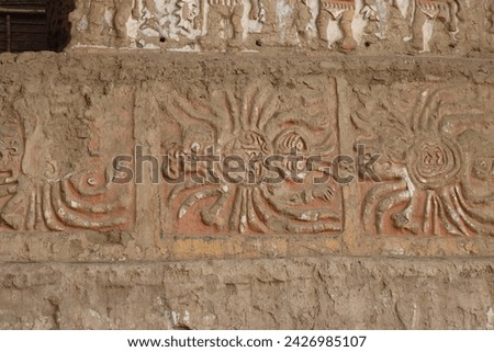 Iconography of the Moche Culture showing their deity Ai Apaec and Moche warriors performing ceremonial rites at the Huaca del Sol at the Archaeological Center in Trujillo, Peru. Royalty-Free Stock Photo #2426985107