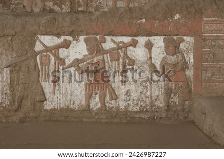 Iconography of the Moche Culture showing their deity Ai Apaec and Moche warriors performing ceremonial rites at the Huaca del Sol at the Archaeological Center in Trujillo, Peru. Royalty-Free Stock Photo #2426987227