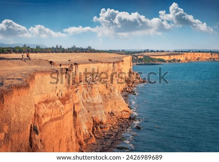 Travel by bicycle on Crimea peninsula. Wonderful simmer view of Lukull red cliff on the sea shore. Amazing morning seascape of Black sea, Crimea, Ukraine, Europe. Beauty of nature concept background.