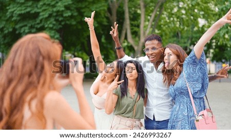 Woman taking a photo of her friends while they are joking