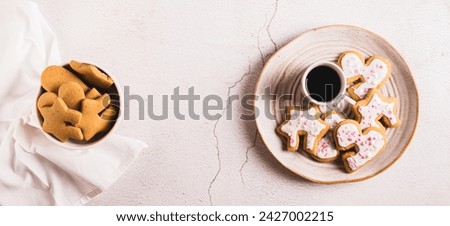 Sweet Mug-Hugging Cookies and cup of coffee on a plate top view web banner