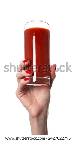 Female hand hold glass of tomato juice, isolated on white background. High quality photo