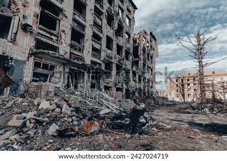 destroyed and burned houses in the city during the war in Ukraine Royalty-Free Stock Photo #2427024719