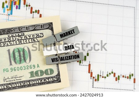 Business concept. On the quote chart there are dollars and clothespins with the inscription - Market Data Visualization