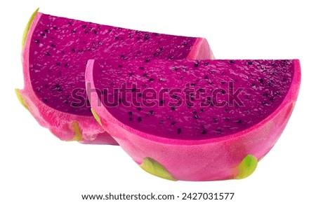 Dragon Fruit handing on tree with other dragon fruit on grass ground