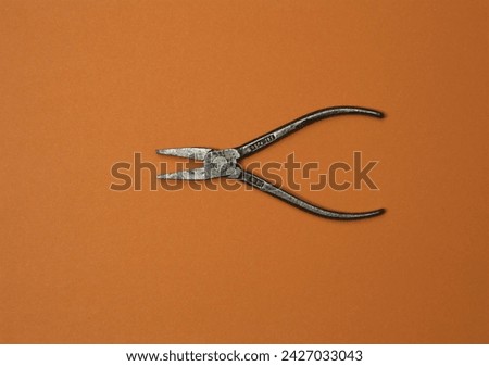 Pliers in action on color background. Loopable stop motion animation. 4K top view. DIY video concept. Royalty-Free Stock Photo #2427033043