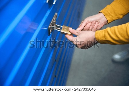 Keys in female hands open a storage room Royalty-Free Stock Photo #2427035045