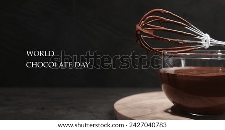 World Chocolate Day. Bowl and whisk with yummy chocolate cream on black table, closeup. Banner design Royalty-Free Stock Photo #2427040783
