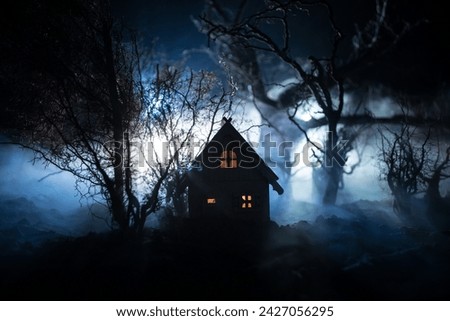 Silhouette of person standing in the dark forest with light. Horror halloween concept. strange silhouette in a dark spooky village