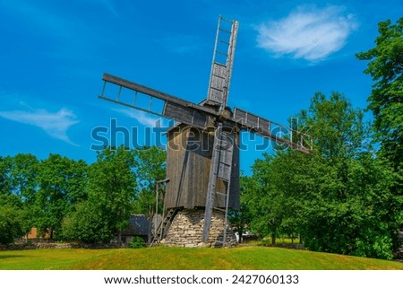 Wooden windmill at Mihkli farmstead museum in Estonia. Royalty-Free Stock Photo #2427060133
