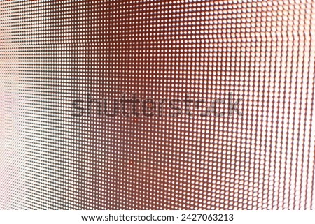 Abstract light gradient texture displayed on an LED screen with red color palette, creating visually dynamic abstract background texture. Royalty-Free Stock Photo #2427063213