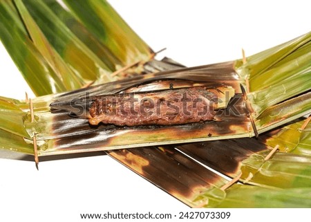 Dessert of Thailand sweetmeat made of flour, coconut and sugar put on the banana leaf,isolated picture.