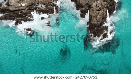 Aerial picture of blue shallow water. Location Bremer Bay in South-west Australia. Drone view. Ocean and rocks with small waves and foamy water. Western Australia wallpaper or background picture.