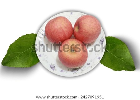 Red Apples on a Ceramic Plate with Leaves, Top View on a White Background