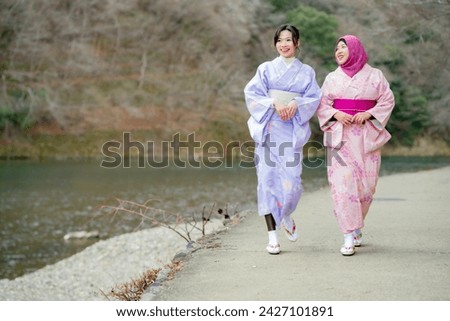 Travel, muslim travel, Arashiyama, woman girl tourist Two Asian friends but different religions in traditional japanese kimonos walking and travel   to Tenryu-ji temple, Kyoto, Arashiyama, Japan.