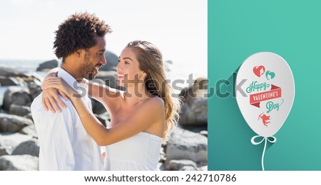 Gorgeous couple embracing by the coast against valentines day greeting