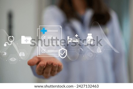 Health insurance concept, Doctor holding virtual graphic insurance form and healthcare medical icon, health and access to welfare health, medical health and life insurance business