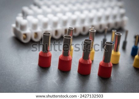 Close up several Wire Ferrule and terminal block w wire on top of a black table Royalty-Free Stock Photo #2427132503